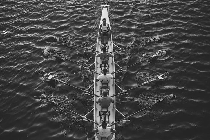 people riding boat on body of water